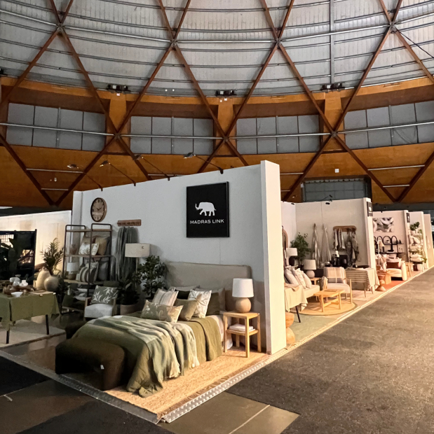 Furniture showroom-style exhibition stand with bedroom and living room settings