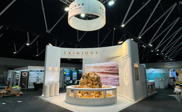 SKIN1004 exhibition stand with a circular hanging sign and curved backwall