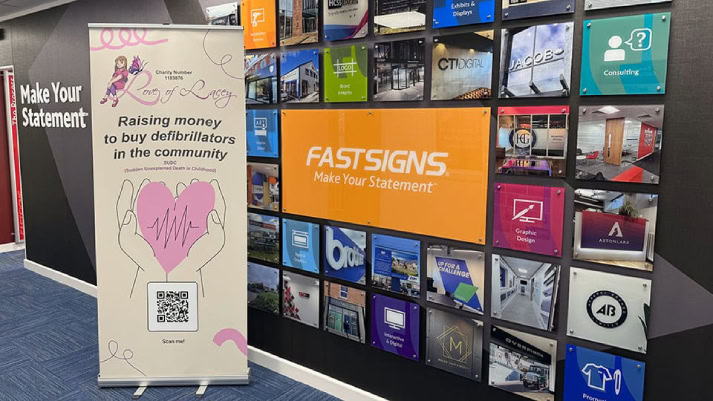 Printed signage wall and pull-up banner at a trade show