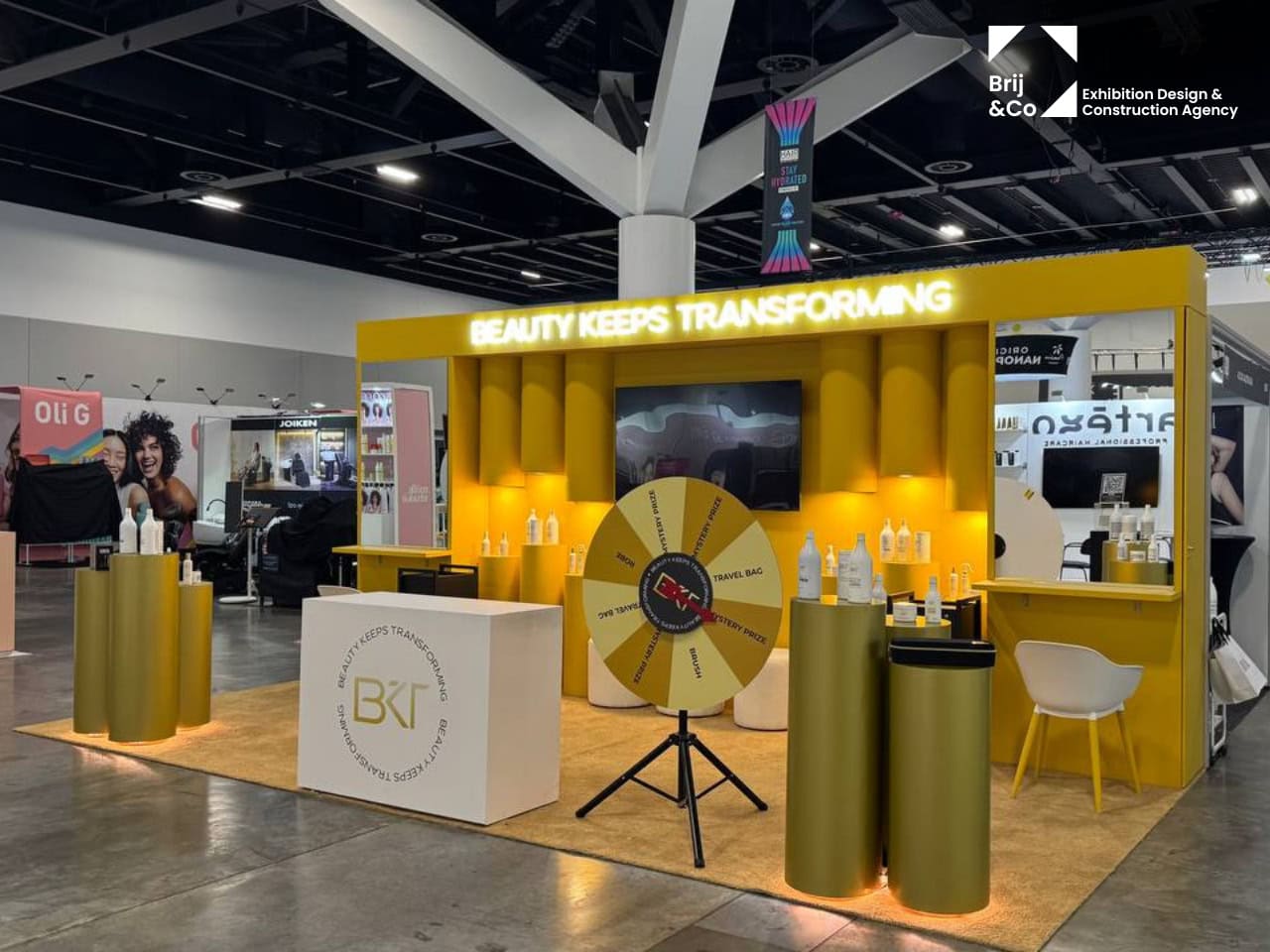 BKT Beauty Keeps Transforming stand with a yellow backwall and prize wheel