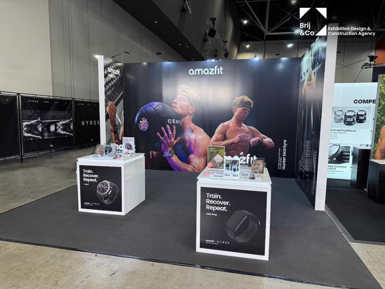 Amazfit exhibition stand with athlete graphics and white product plinths