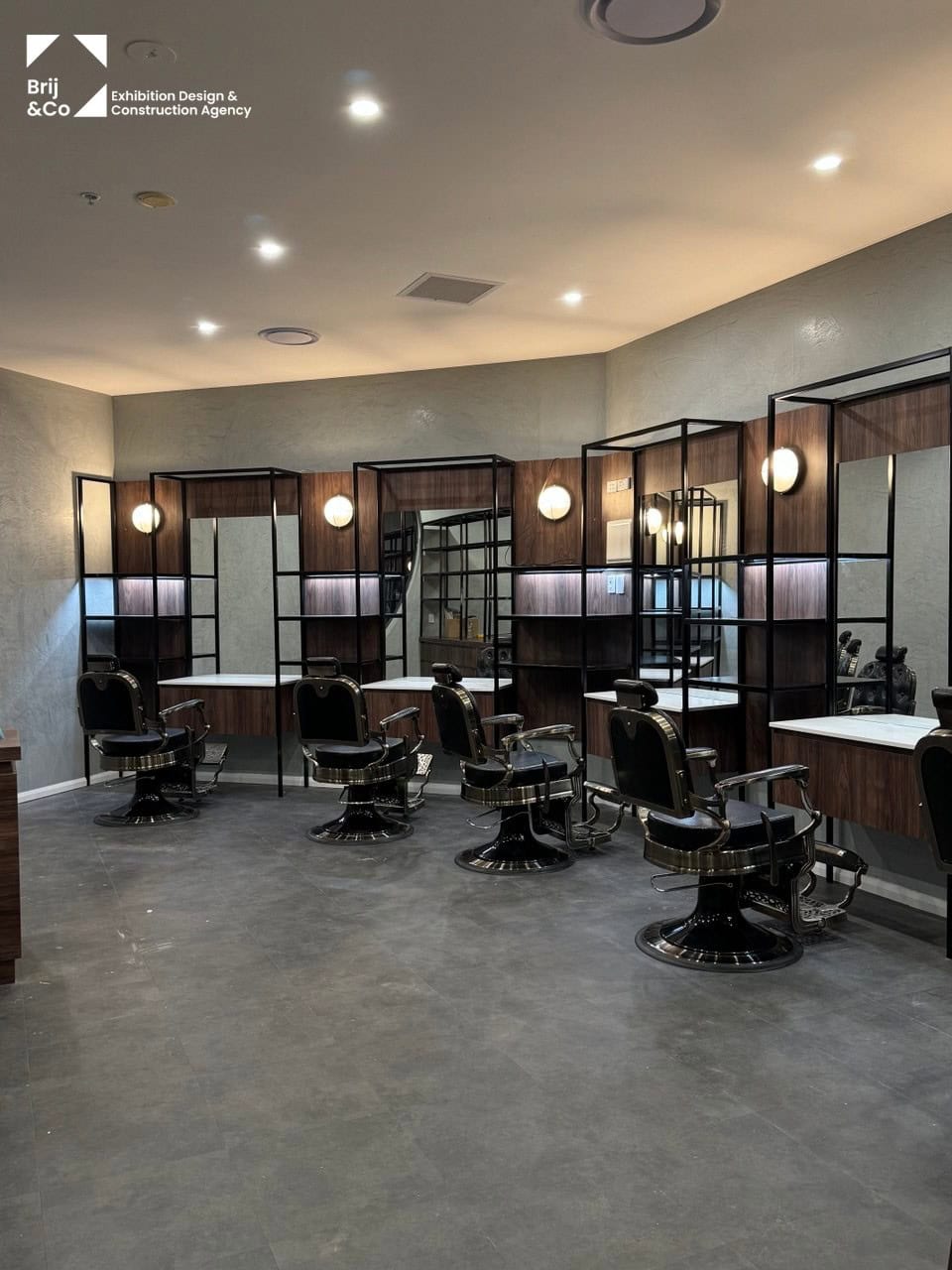 Barbershop interior fit-out with barber stations and wall lights