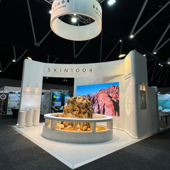 SKIN1004 exhibition stand with a curved backwall and circular hanging sign