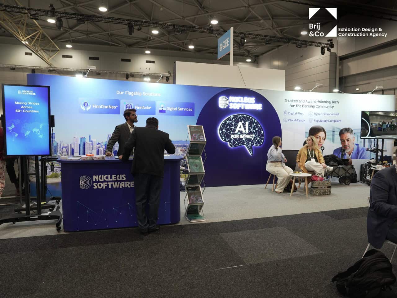 Nucleus Software exhibition stand with a blue backwall, screen and meeting area
