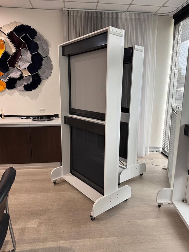 Mobile product display stand with a framed panel in a showroom