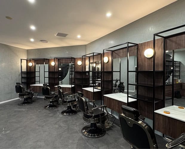 Barbershop fit-out with barber chairs, timber stations and wall lights