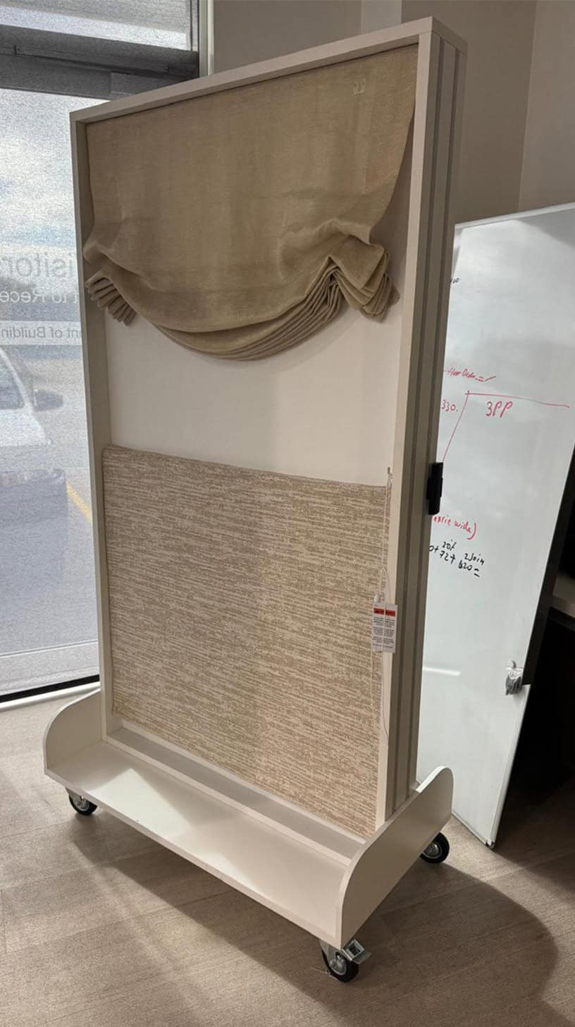 Verosol display stand with a fabric blind sample on castors
