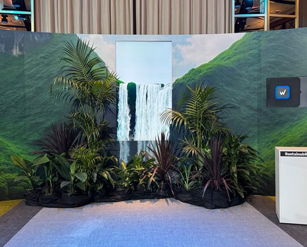 Event backdrop with a painted waterfall and tropical planting