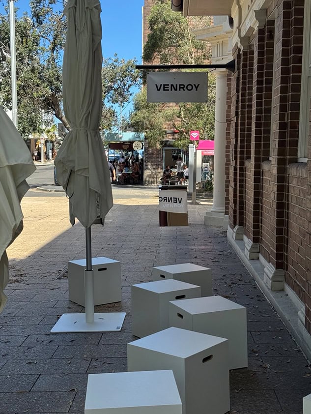 Venroy outdoor pop-up with white cube seating and an umbrella