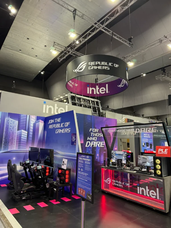 ASUS Republic of Gamers stand with a hanging Intel sign and gaming displays