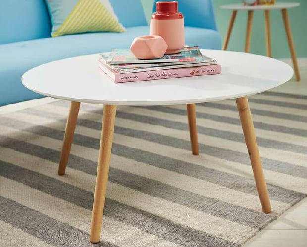 Hire furniture: round white coffee table with timber legs