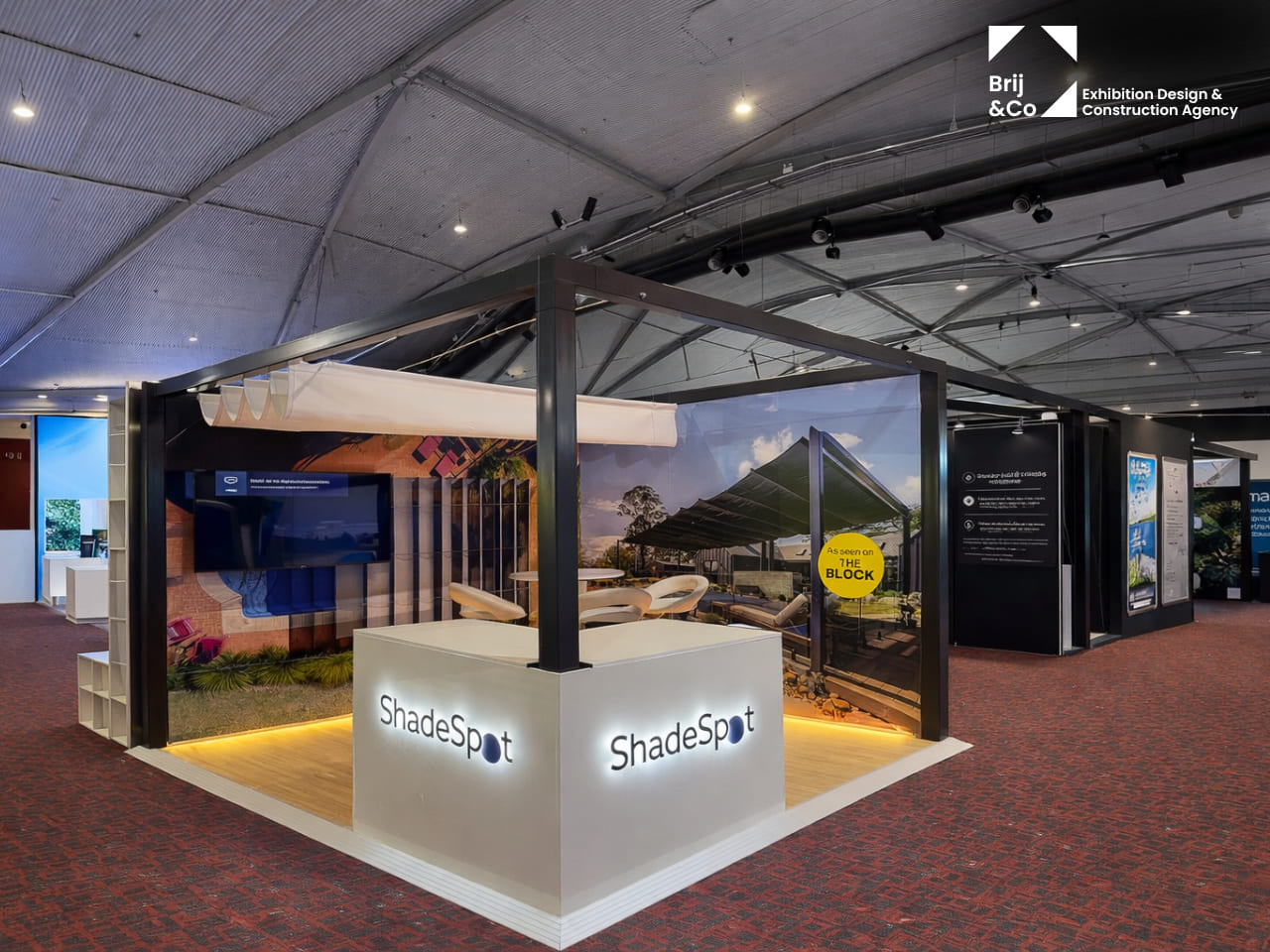 ShadeSpot exhibition stand with an outdoor shade frame and lit branded counters