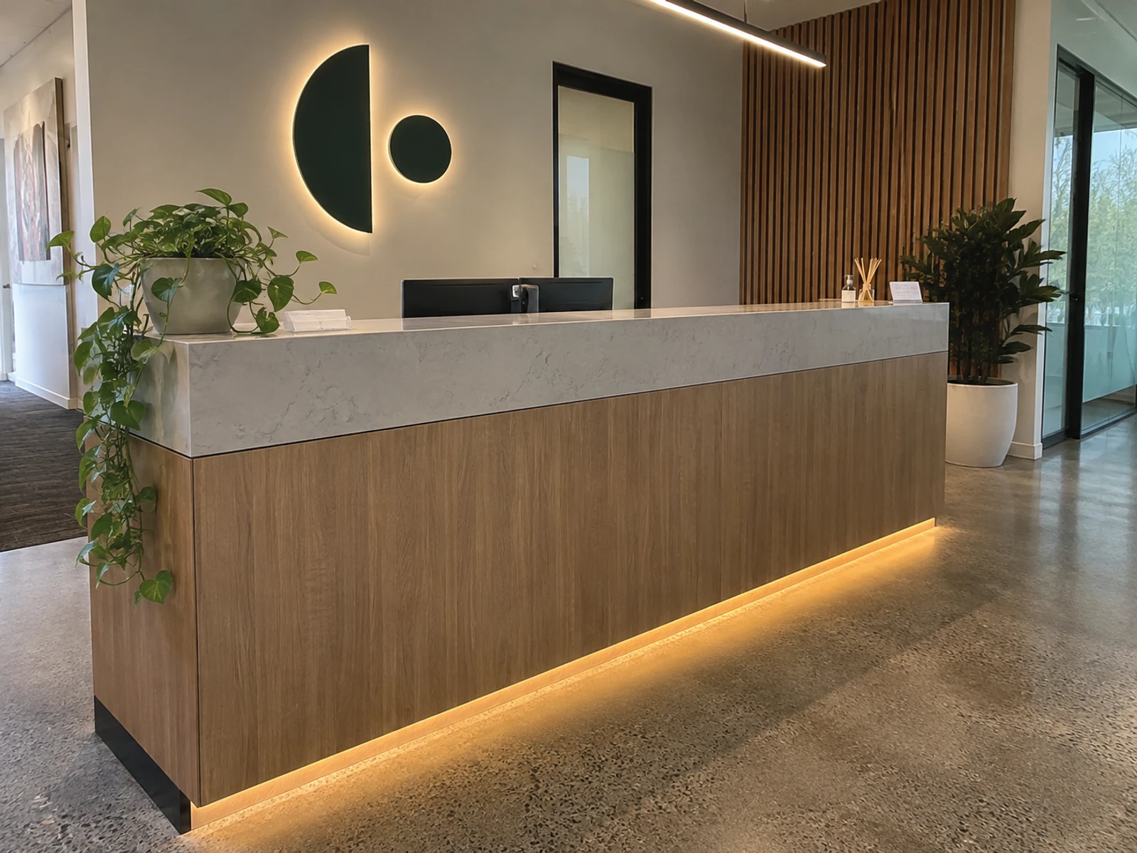 Finished custom reception counter with timber veneer front and stone-look top