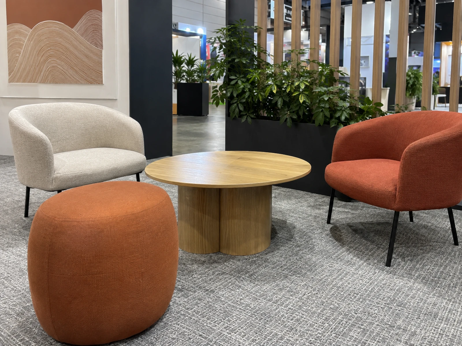 Hire lounge chairs, ottomans and a coffee table arranged in an event space