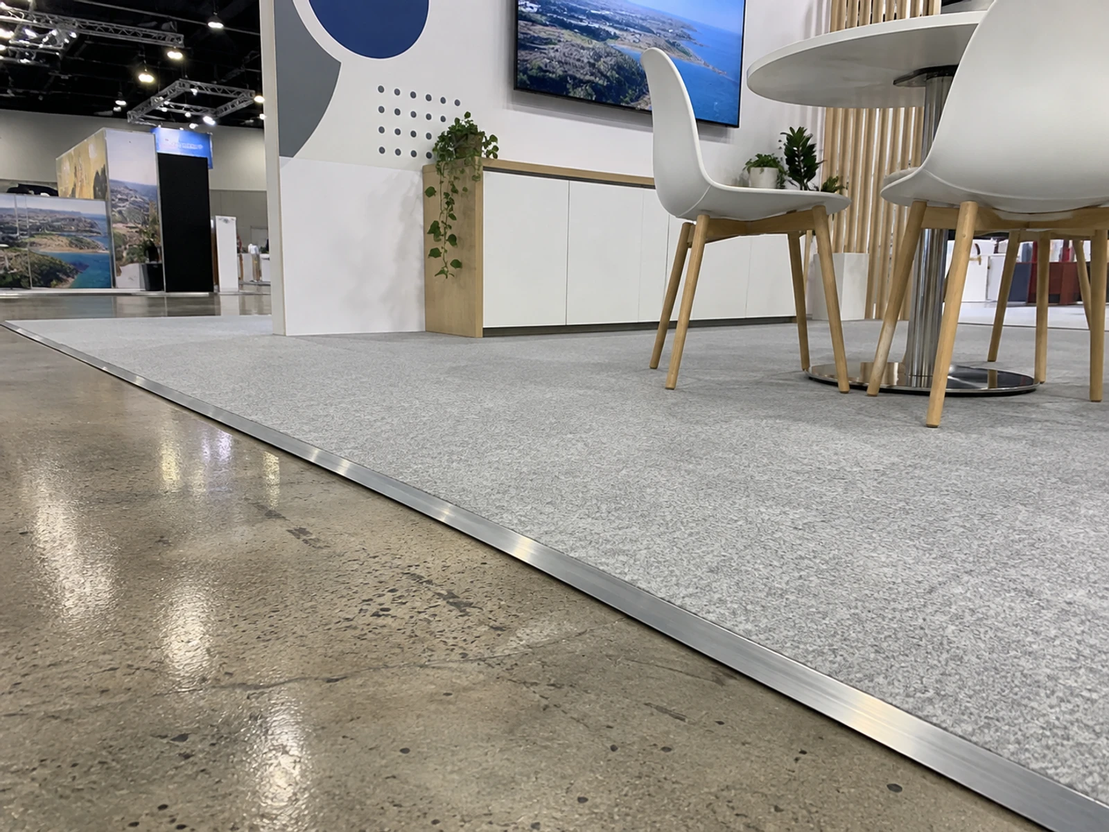 Carpeted exhibition flooring with a neat edge trim on a stand