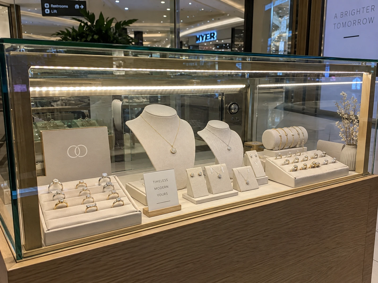 Lit glass jewellery showcase built into a kiosk counter