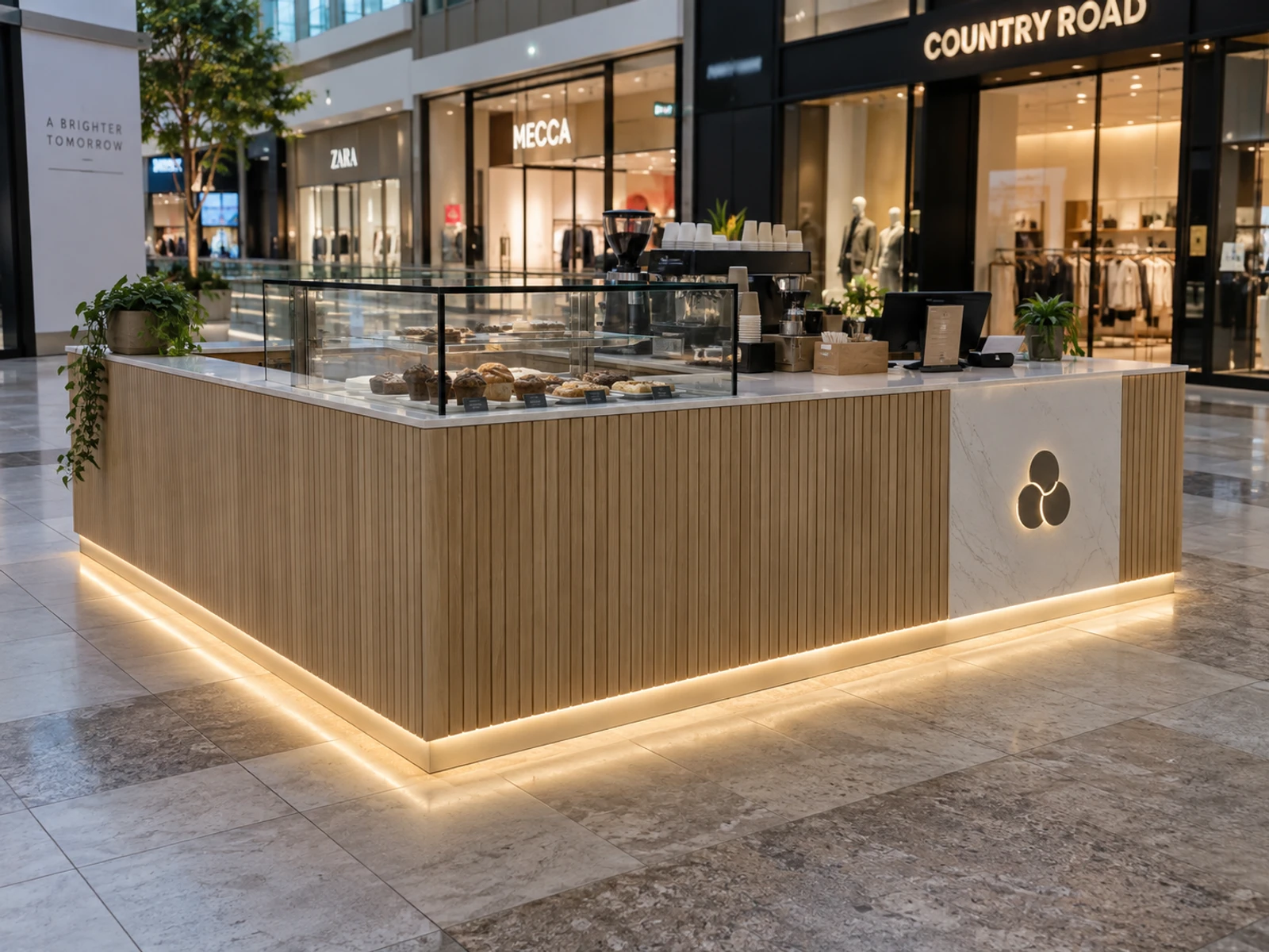 Freestanding shopping centre kiosk with a marble-look counter and lit base in a mall