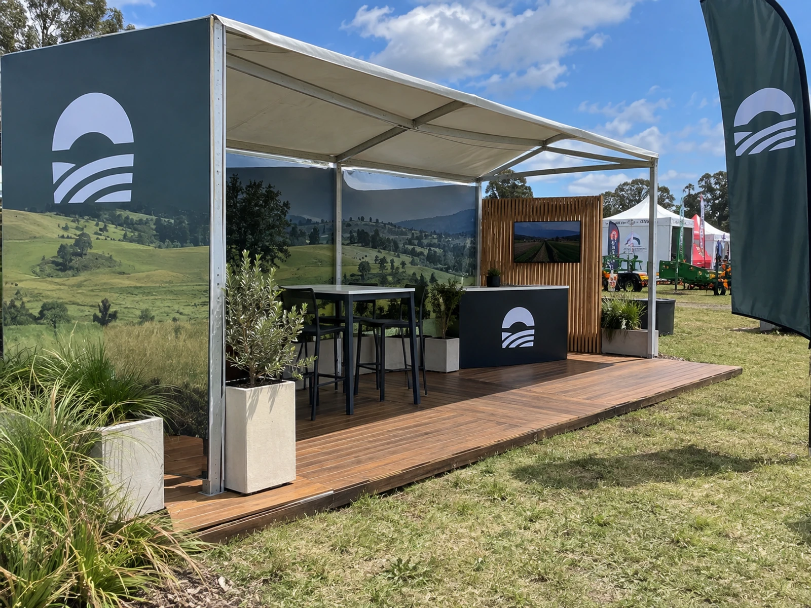 Outdoor exhibition stand with a shade structure and timber decking at a field day