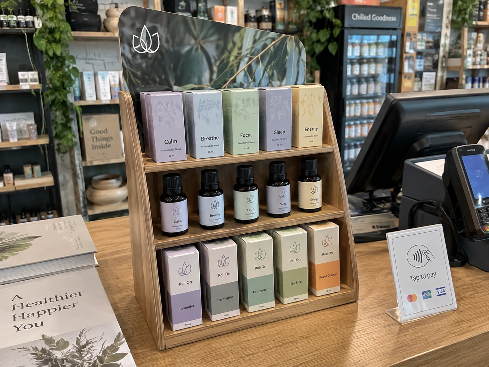 Timber counter point of sale display holding skincare products beside a shop register