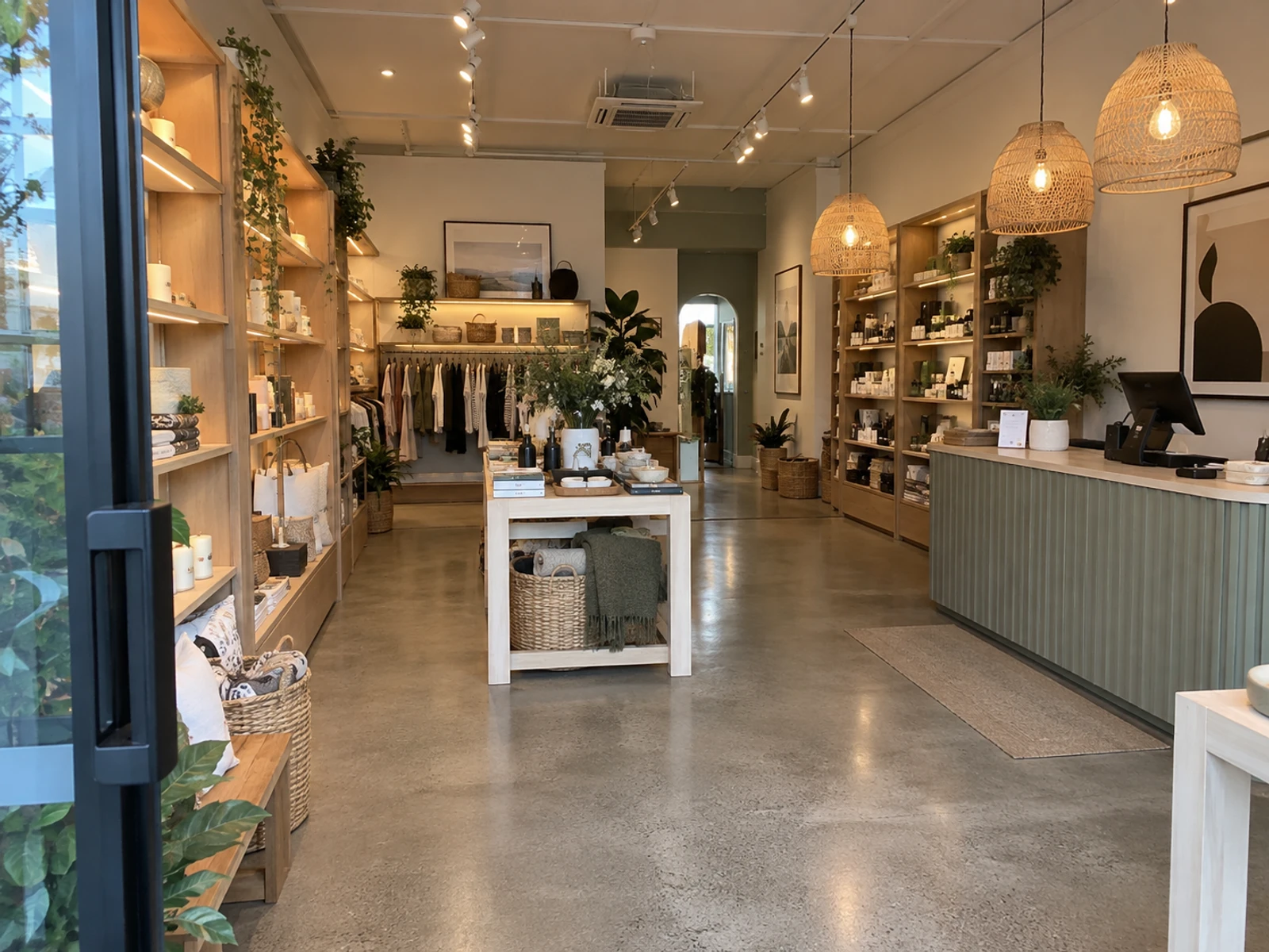 Finished boutique fitout in Sydney with timber wall displays, a cash-wrap and feature lighting