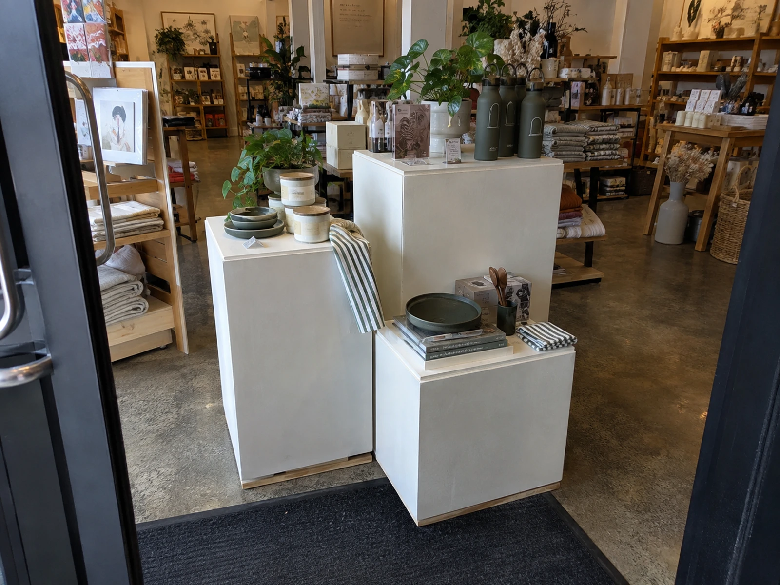 Feature table with nested plinths displaying products near a store entrance